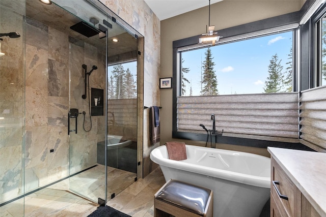bathroom featuring vanity, a freestanding tub, and a shower stall