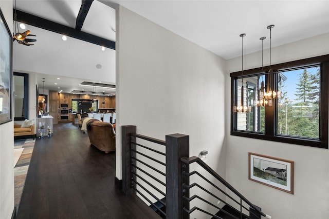 interior space with recessed lighting, beamed ceiling, an inviting chandelier, and wood finished floors