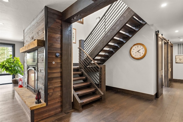 stairway featuring baseboards, recessed lighting, and hardwood / wood-style floors
