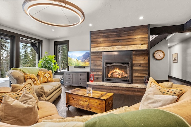 living area with recessed lighting, baseboards, wood finished floors, and a large fireplace