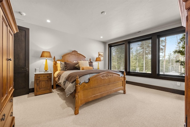 bedroom with baseboards, light carpet, and recessed lighting