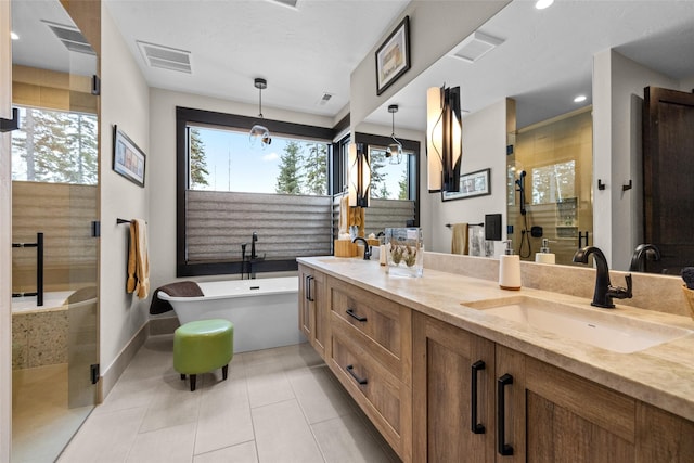 bathroom featuring visible vents, a sink, a stall shower, and a healthy amount of sunlight