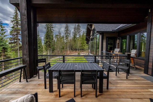 wooden terrace with outdoor dining area