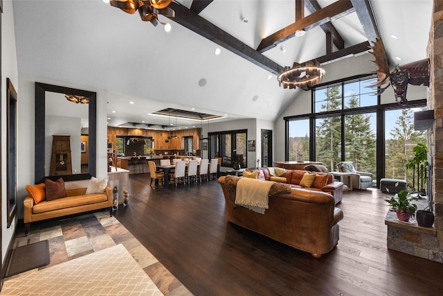 living area featuring beamed ceiling, high vaulted ceiling, an inviting chandelier, and dark wood-style floors