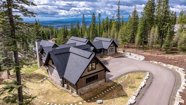 drone / aerial view with a mountain view and a forest view