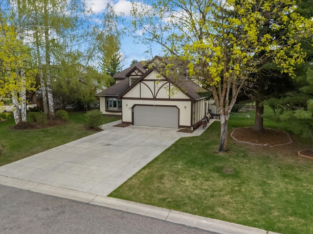 128 River View Dr, Kalispell, MT 59901 - view of front of house featuring a garage, a front lawn, concrete driveway, stucco siding, and a shingled roof