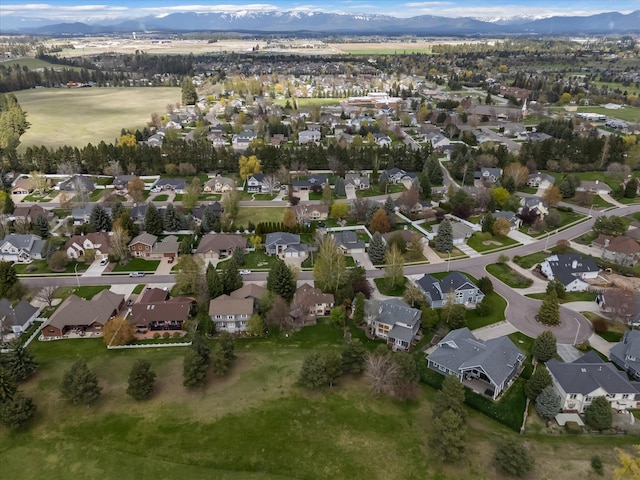 128 River View Dr, Kalispell, MT 59901 - aerial view of property and surrounding area with nearby suburban area and a mountain backdrop