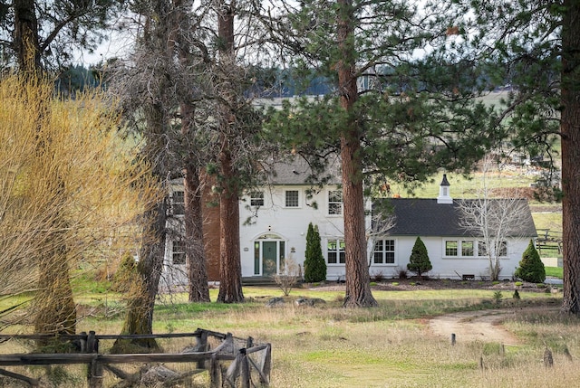 back of house with fence and a shingled roof