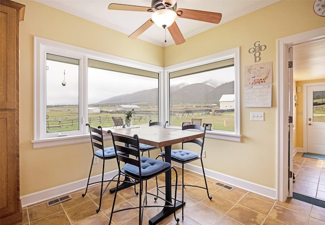 dining space featuring a wealth of natural light, ornamental molding, and visible vents