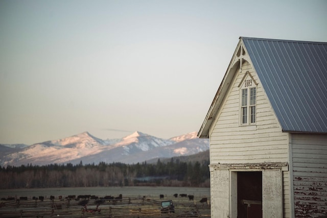 view of side of property with metal roof and a mountain view