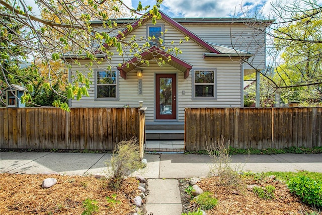 bungalow-style house with a fenced front yard