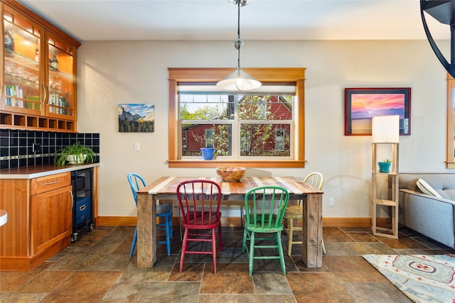 dining area featuring baseboards and stone tile floors