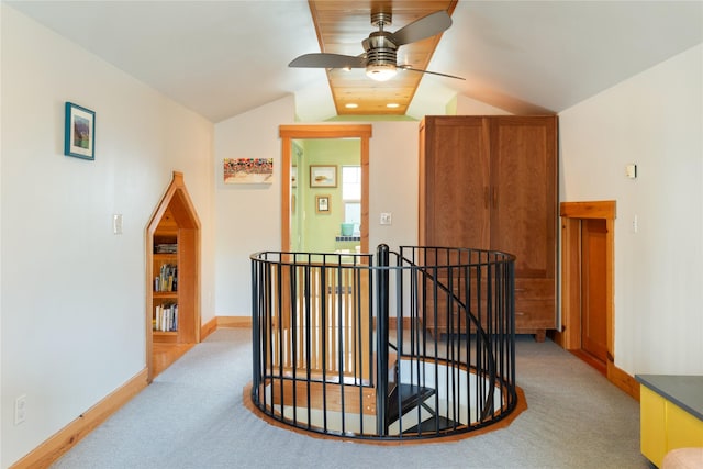 hallway with baseboards, an upstairs landing, light carpet, and lofted ceiling