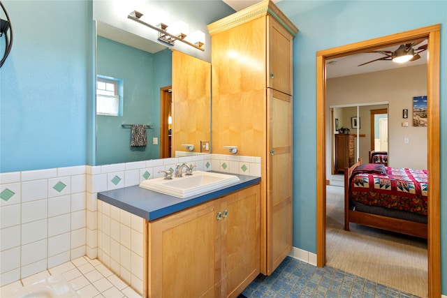 bathroom featuring a ceiling fan, ensuite bathroom, and vanity