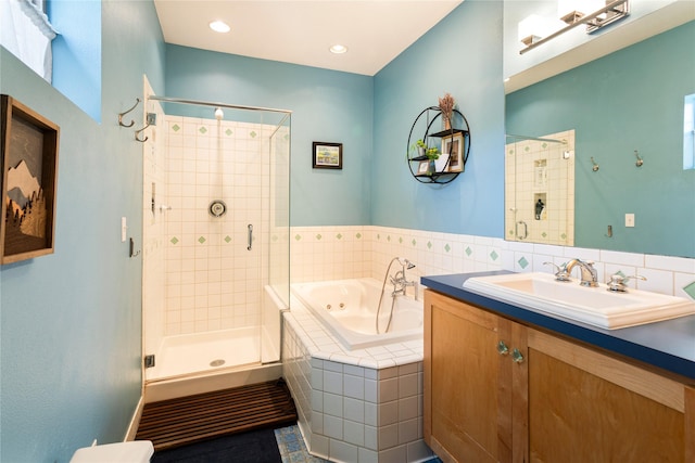 full bath with recessed lighting, vanity, a shower stall, and a tub with jets