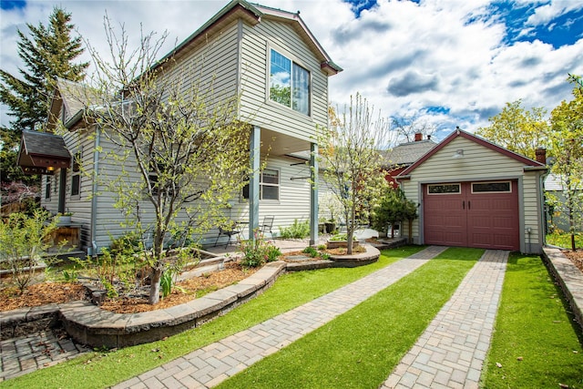 traditional home featuring a garage, a front lawn, and driveway