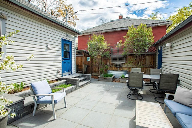 view of patio featuring fence and outdoor dining space