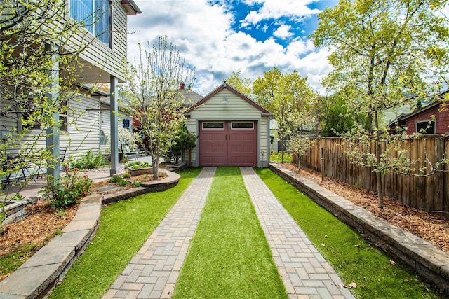 view of yard featuring fence and driveway