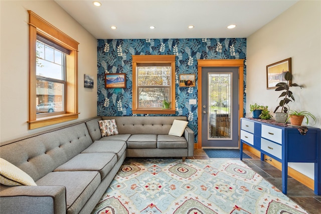 sitting room featuring wallpapered walls and plenty of natural light