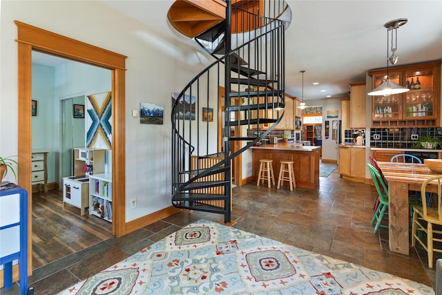 stairs featuring recessed lighting, baseboards, and stone finish flooring