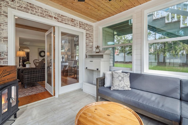 sunroom featuring a healthy amount of sunlight and an outdoor living space