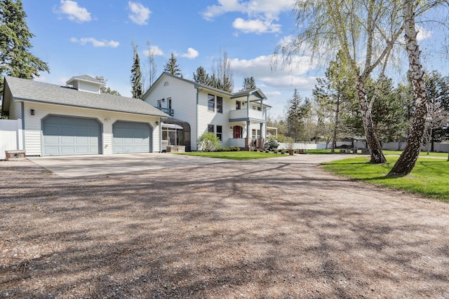 view of front of house with fence, an attached garage, and concrete driveway