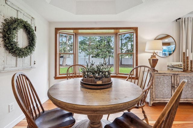 dining area with light wood-style floors and baseboards
