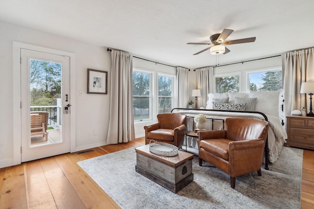 bedroom with visible vents, access to exterior, baseboards, ceiling fan, and light wood finished floors
