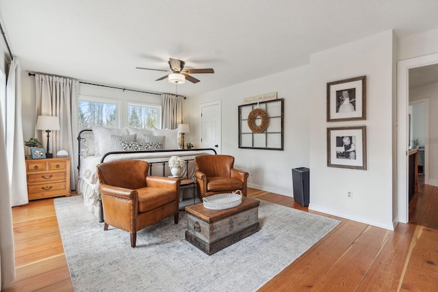 bedroom with baseboards, a ceiling fan, and light wood finished floors
