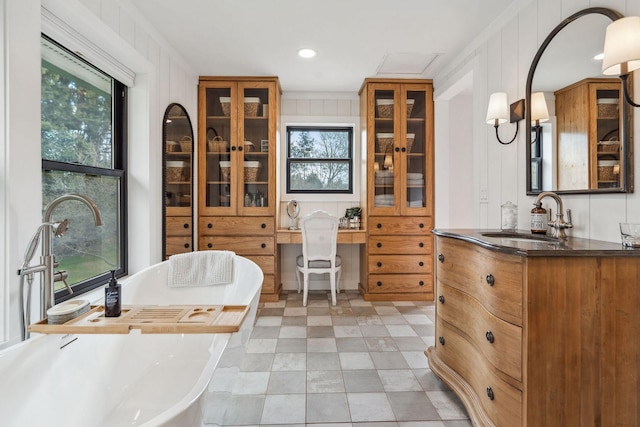 full bath featuring a freestanding bath and vanity