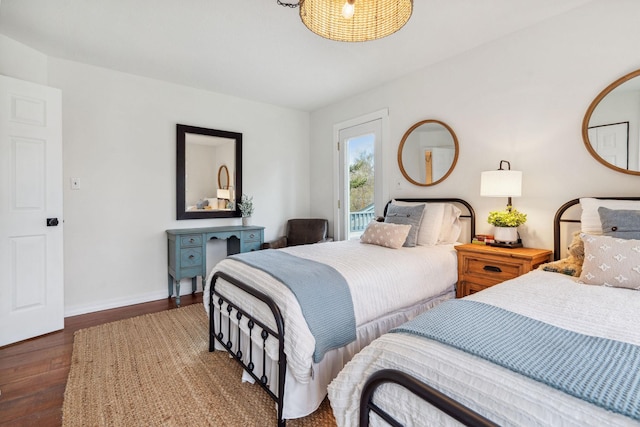 bedroom with access to outside, baseboards, and wood finished floors