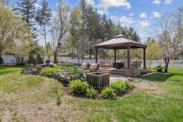 view of yard with a gazebo, an outdoor living space, a wooden deck, and a fenced backyard