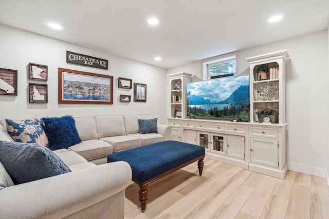 living area featuring recessed lighting, baseboards, and light wood finished floors