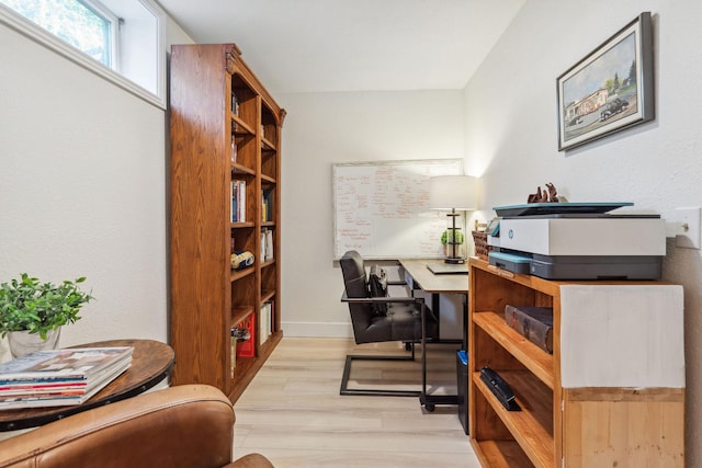 office space featuring light wood-style floors and baseboards