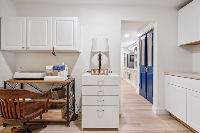 office space with light wood-type flooring, recessed lighting, and baseboards