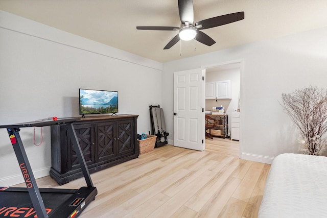 workout area featuring baseboards, a ceiling fan, and wood finished floors