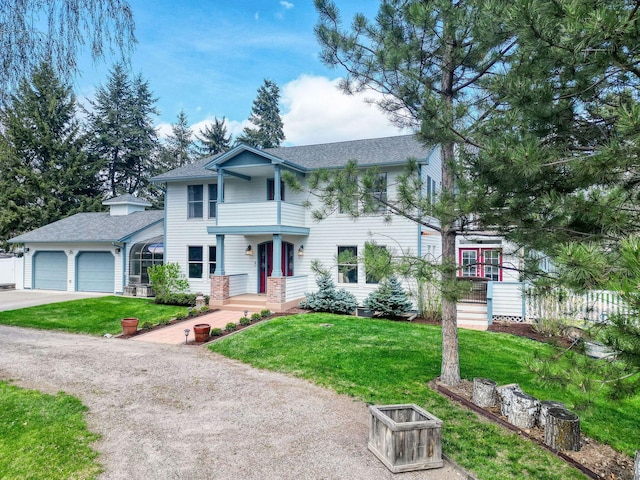 view of front of house featuring concrete driveway, an attached garage, roof with shingles, and a front lawn