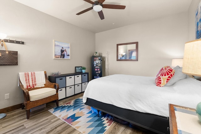bedroom with baseboards, a ceiling fan, and wood finished floors