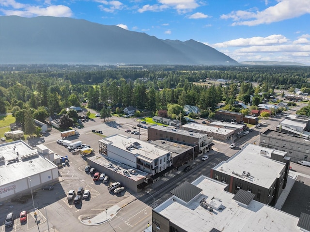 drone / aerial view with a mountain view and a wooded view