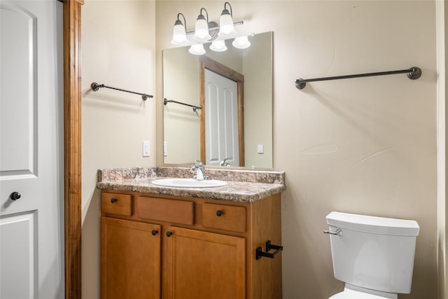 bathroom with toilet and vanity