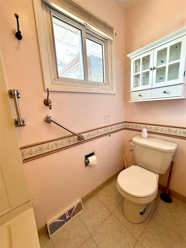 bathroom featuring visible vents, tile patterned flooring, and toilet
