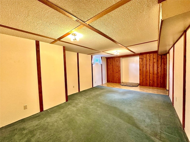 finished basement with carpet flooring and a textured ceiling