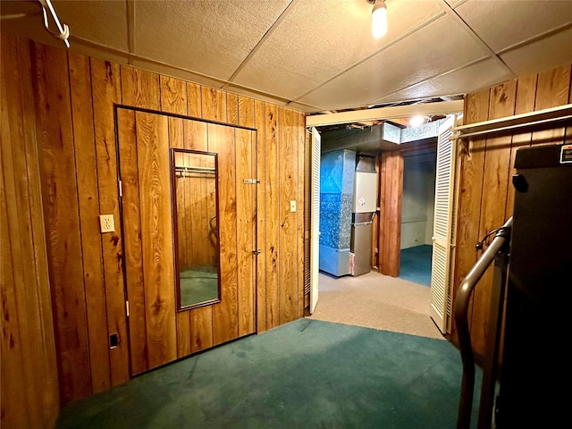 interior space with carpet floors and wooden walls