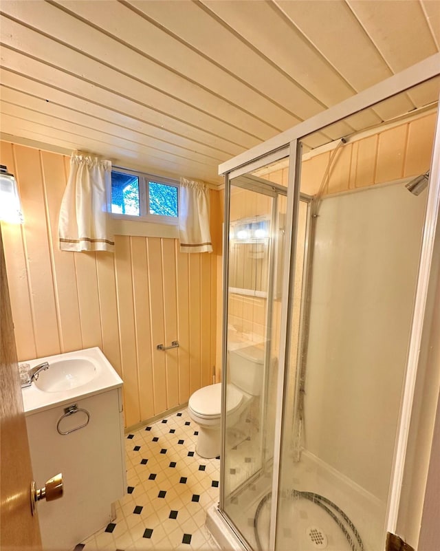 full bathroom with vanity, tile patterned floors, a stall shower, and toilet