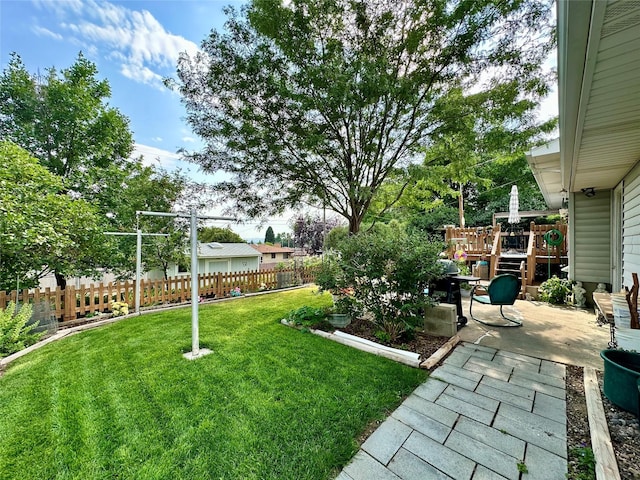 view of yard featuring fence and a patio