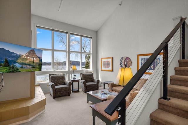 living room featuring high vaulted ceiling, carpet, a wealth of natural light, and stairway