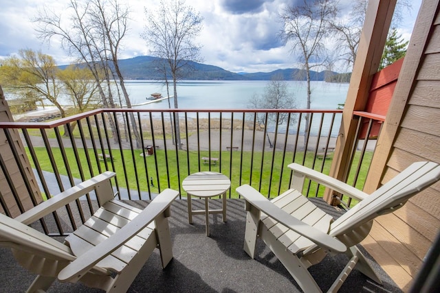 balcony featuring a water and mountain view