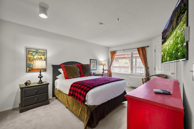 bedroom featuring baseboards and light carpet