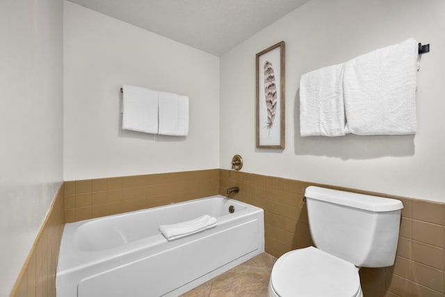 1400 Wisconsin Ave Unit 308, Whitefish, MT 59937 - full bathroom featuring a bath, a wainscoted wall, tile walls, and tile patterned flooring