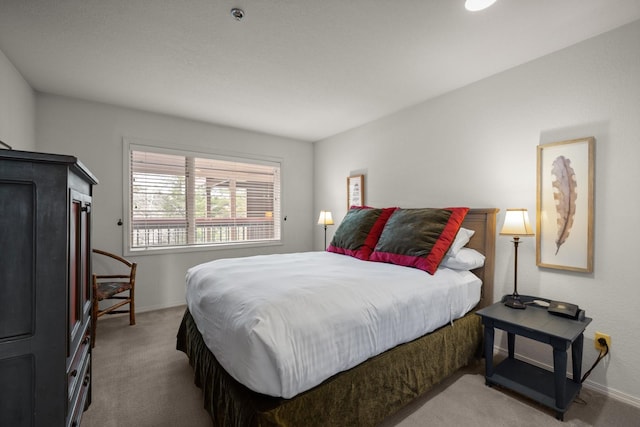 bedroom with carpet floors and baseboards